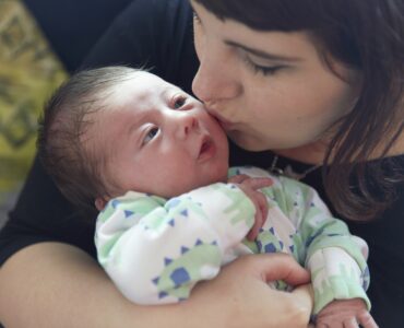 A photograph of Charlotte and her baby son taken by Natalie J Weddings Photography.